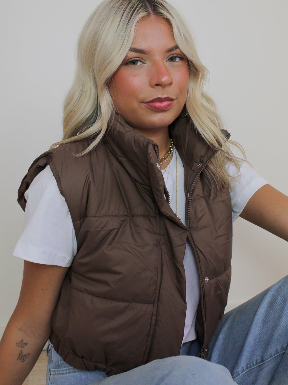 Girl wearing a fall outfit featuring a Brown puffer vest