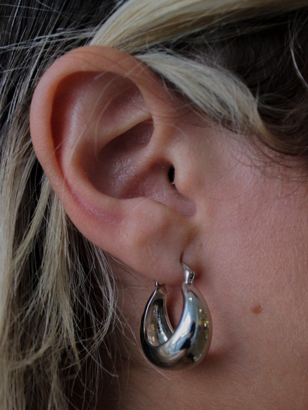 A bold chunky silver hoop earring