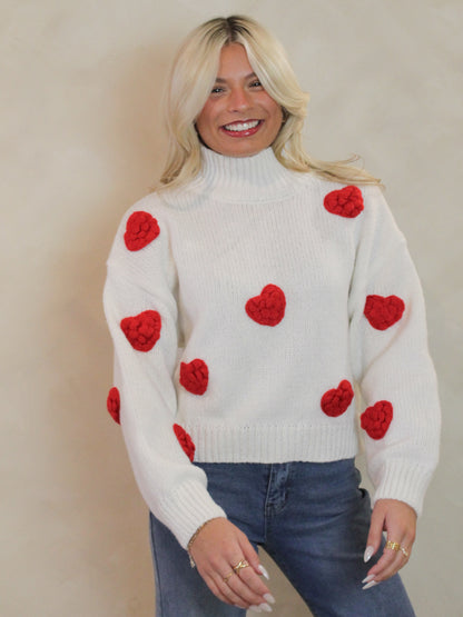 Cute chunky knit sweater with puffy hearts all over and at cozy turtle neck