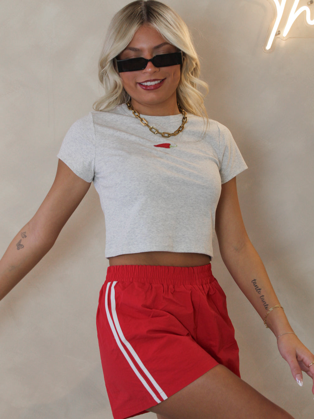 Red nylon track short outfit