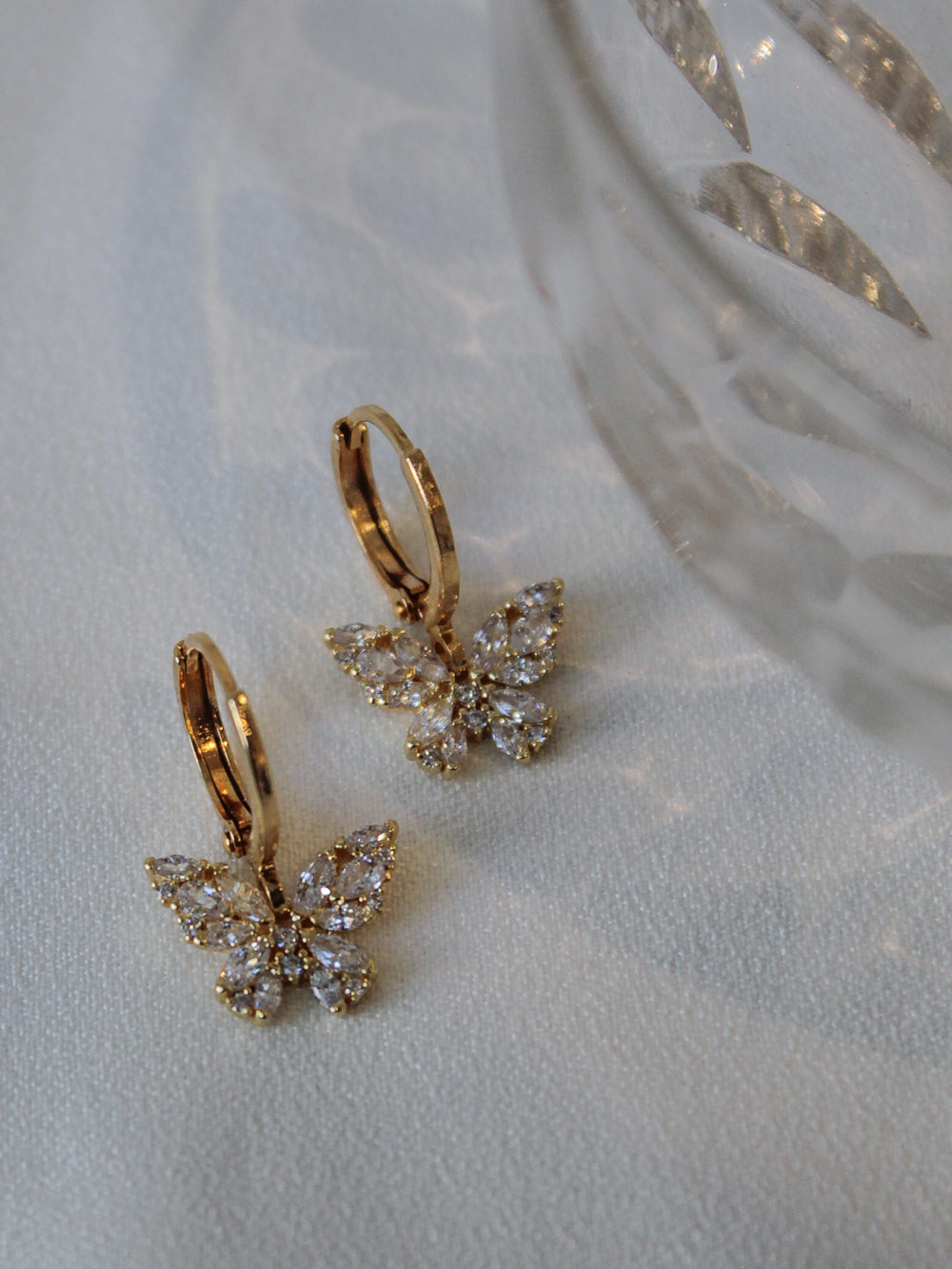 Petite gold butterfly huggie earrings
