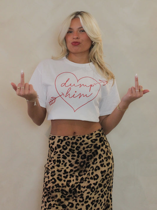 White tee with a heart graphic that says dump him paired with a leopard skirt 